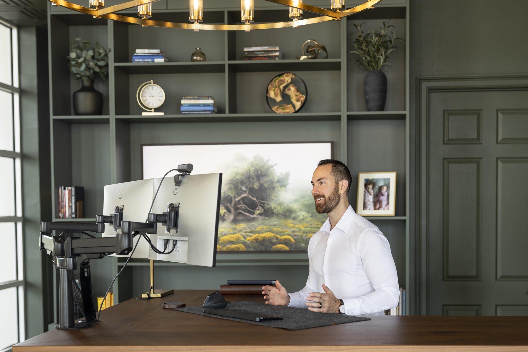 Dual monitors on the desk in the True Stewards Advisory office